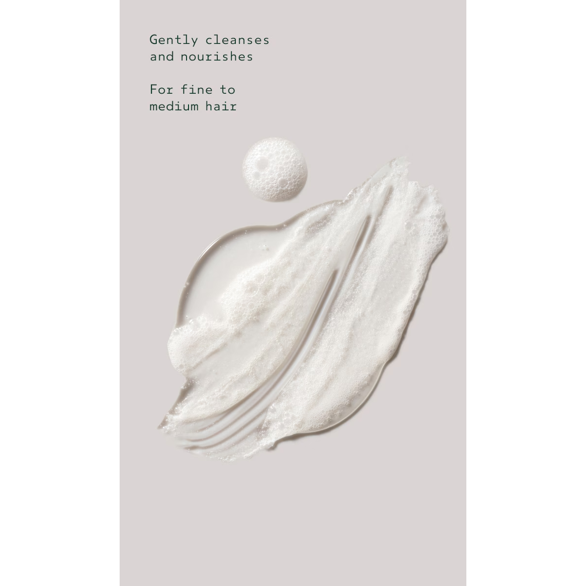A smear of Shampure Nurturing Shampoo, clear and foaming, on a light gray background with the text: “Gently cleanses and nourishes. For fine to medium hair.” - SAAB Salon Spa | Ottawa On, Canada
