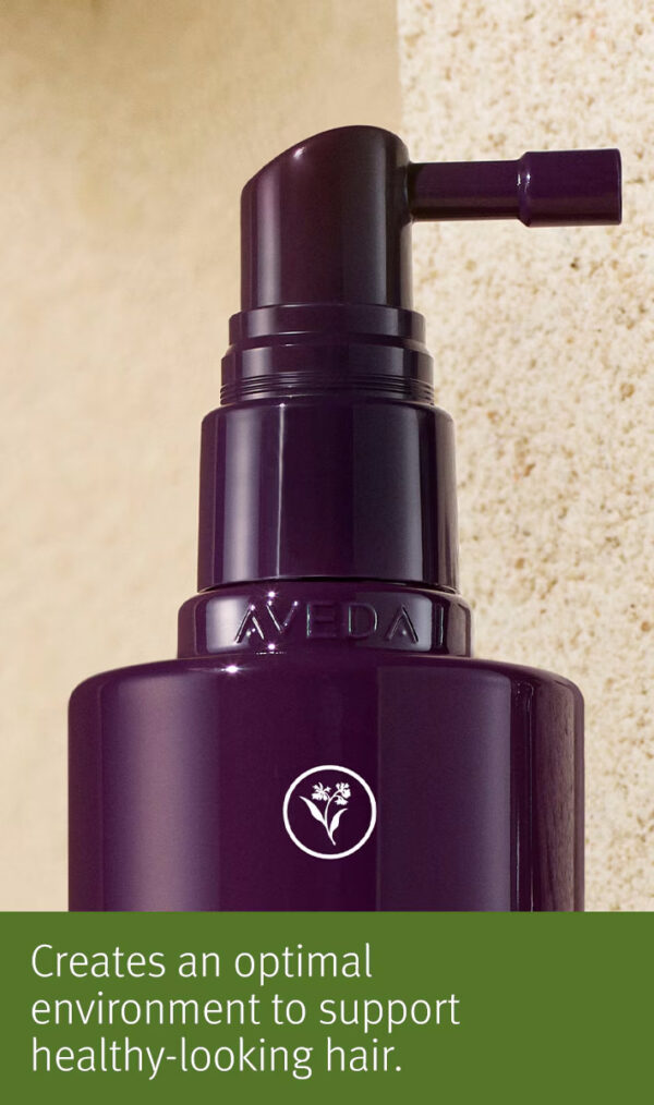 Close-up of a dark purple Invati advanced scalp revitalizer pump bottle against a beige textured background with text stating, "Creates an optimal environment to support healthy-looking hair. - SAAB Salon Spa | Ottawa On, Canada