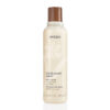 A tall, cylindrical bottle of Rosemary Mint Body Lotion featuring a brown cap and labels in English and French. - SAAB Salon Spa | Ottawa On, Canada