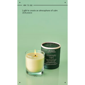 A Rosemary Mint Vegan Soy Wax Candle in a clear glass jar next to its cylindrical green cardboard lid, with instructions above reading, “Light to create an atmosphere of calm and peace.” - SAAB Salon Spa | Ottawa On, Canada