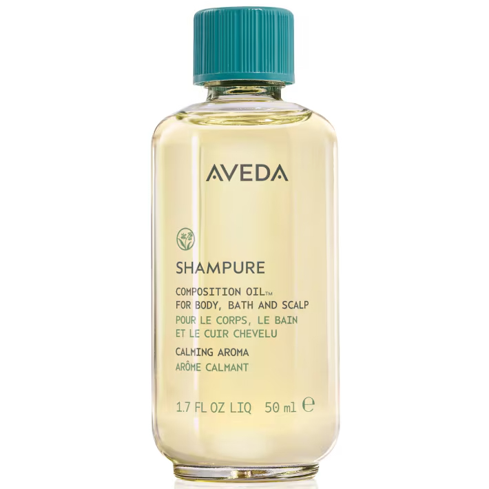 A clear bottle of Shampure Composition Oil featuring pale yellow oil, a teal screw cap, and text on the label. - SAAB Salon Spa | Ottawa On, Canada