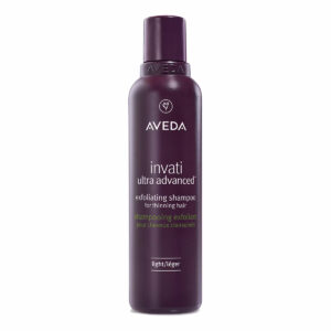 A bottle of Invati Advanced Exfoliating Shampoo - Light for thinning hair, featuring a purple design and text in English and French. - SAAB Salon Spa | Ottawa On, Canada