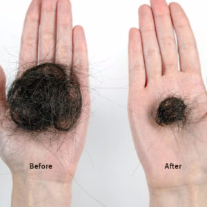 Two hands holding clumps of hair with 