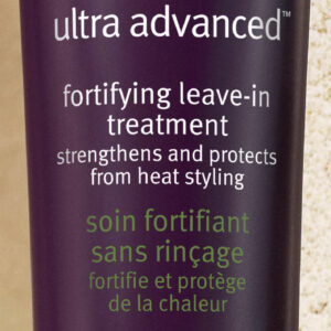 Close-up image of a bottle labeled "Invati Ultra Advanced Fortifying Leave-In Treatment" with text in English and French highlighting its benefits. Text at the bottom reads, "Detangles and strengthens, protecting from hair fall due to breakage. - SAAB Salon Spa | Ottawa On, Canada