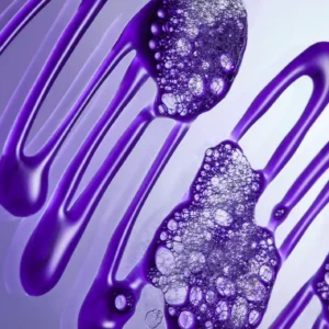 Close-up of NEW botanical repair™ purple toning shampoo with streaks of purple liquid and clusters of transparent bubbles on a smooth surface, set against a gradient light background. - SAAB Salon Spa | Ottawa On, Canada