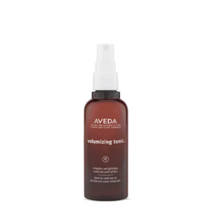 A brown spray bottle of Volumizing Tonic with white text on the label, displayed against a plain white background. - SAAB Salon Spa | Ottawa On, Canada