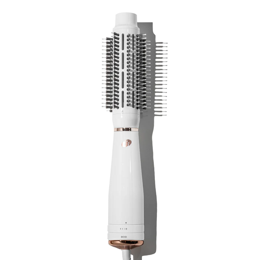 The T3 Airebrush (Copy), a white and rose gold hot air brush with a cylindrical barrel and bristles, is shown on a white background. - SAAB Salon Spa | Ottawa On, Canada