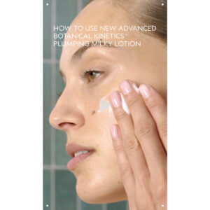 A person applies Advanced Botanical Kinetics Plumping Milky Lotion to their cheek with their fingers, demonstrating its use as a hydrating skincare lotion. Text highlights the advanced botanical and plumping benefits of the milky formula. - SAAB Salon Spa | Ottawa On, Canada