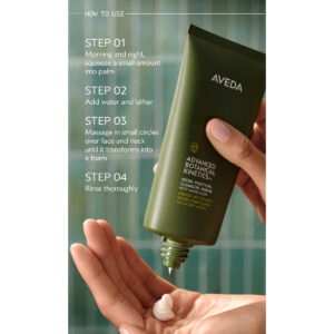 A person squeezes Advanced Botanical Kinetics Revitalizing Essence Lotion onto their palm, with usage instructions visible in the background. - SAAB Salon Spa | Ottawa On, Canada