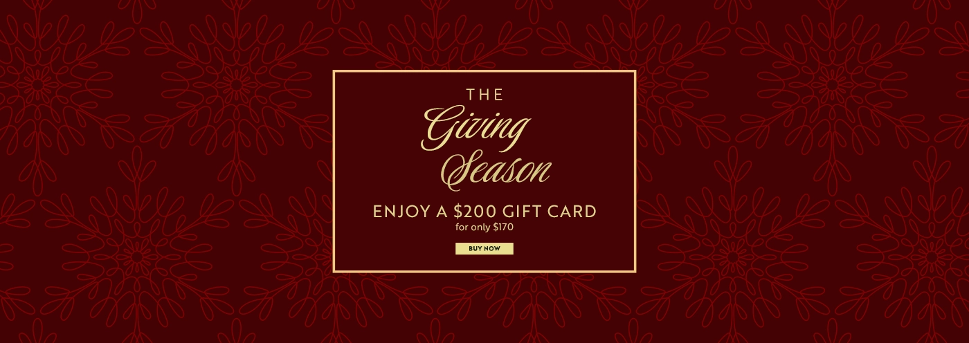 The Giving Season promotion offering a $200 gift card for $170 with a “Buy Now” button on a deep red background with a snowflake pattern. - SAAB Salon Spa | Ottawa On, Canada