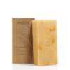 Rectangular Beautifying Bath Bar with mottled texture next to its upright cardboard packaging. - SAAB Salon Spa | Ottawa On, Canada