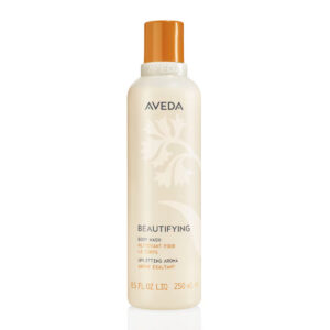 A tall, cylindrical bottle of Beautifying Body Wash with an orange cap and a floral graphic. - SAAB Salon Spa | Ottawa On, Canada