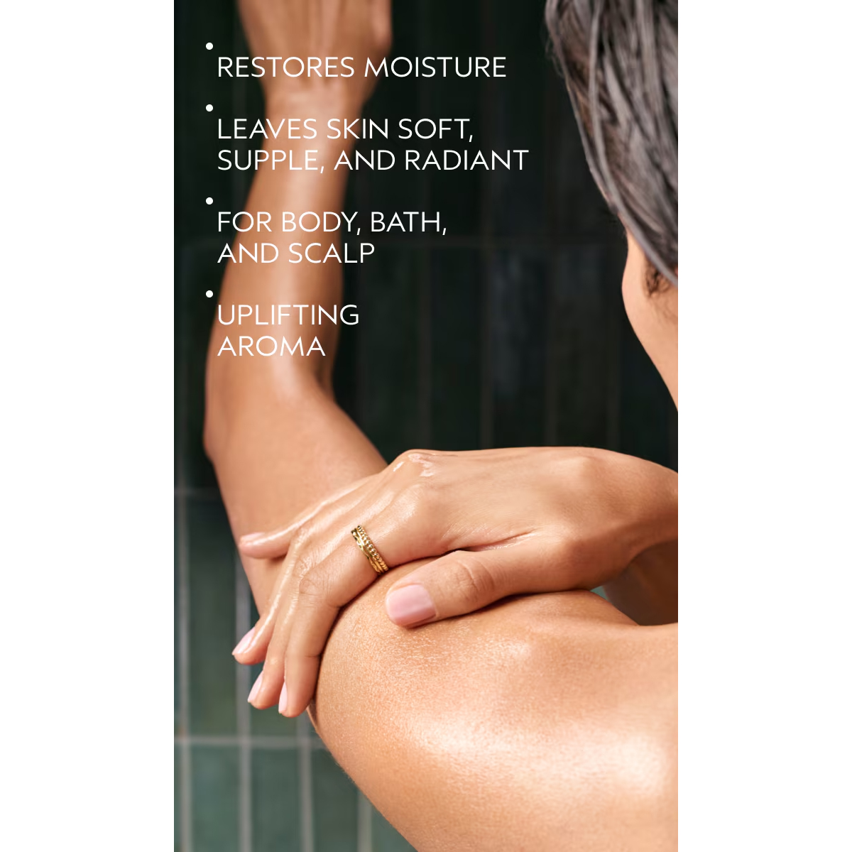 A person applies Beautifying Composition Oil to their shoulder, which restores moisture to leave skin soft, supple, and radiant. - SAAB Salon Spa | Ottawa On, Canada