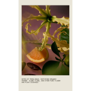 A Cherry Almond Bath Bar featured with a ylang-ylang flower, a slice of orange, and a tonka bean with text listing ingredient notes. - SAAB Salon Spa | Ottawa On, Canada