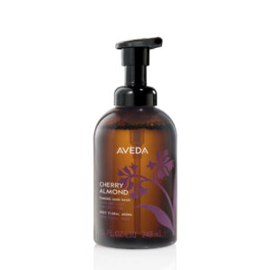 Amber-colored bottle of Cherry Almond Foaming Hand Wash with a black pump dispenser and a purple floral graphic. - SAAB Salon Spa | Ottawa On, Canada