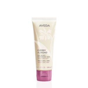 A 100 ml tube of Cherry Almond Hand Relief Moisturizing Creme with a pale yellow body, a floral design, and a plum-colored flip-top cap. - SAAB Salon Spa | Ottawa On, Canada