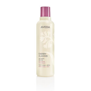 Cylindrical bottle of Cherry Almond Softening Shampoo with a purple cap and light beige label featuring floral graphics and text. - SAAB Salon Spa | Ottawa On, Canada