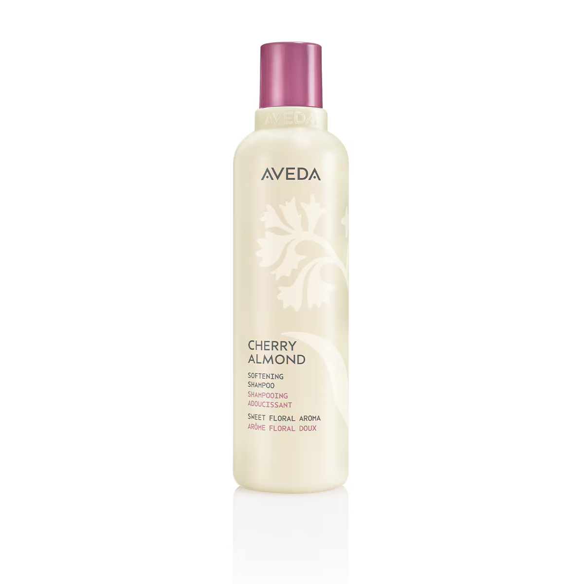 Cylindrical bottle of Cherry Almond Softening Shampoo with a purple cap and light beige label featuring floral graphics and text. - SAAB Salon Spa | Ottawa On, Canada