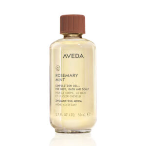 Clear glass bottle of Rosemary Mint Composition Oil For Body, Bath And Scalp with a brown cap and product label text. - SAAB Salon Spa | Ottawa On, Canada