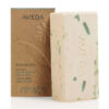 Rectangular beige Shampure Bath Bar with green flecks and a brand name embossed on the side, standing next to its brown cardboard packaging. - SAAB Salon Spa | Ottawa On, Canada