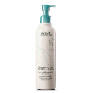 A tall, cylindrical bottle of Shampure Hand and Body wash with a teal pump dispenser and a floral line drawing on the front. - SAAB Salon Spa | Ottawa On, Canada